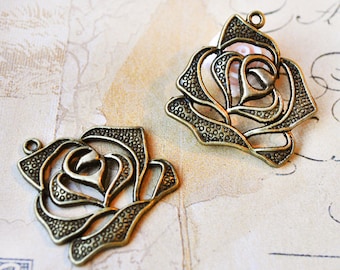 2 intricate rose-shaped pendants