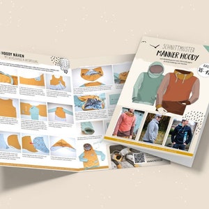 Könnte beinhalten: Ein Nähmusterheft für einen Kapuzenpullover mit Anleitungen und Illustrationen. Das Cover zeigt eine bunte Illustration eines Kapuzenpullovers in zwei Farbvarianten. Der Titel des Musters ist "Manner Hoodie" und die Größen sind XS-XL.