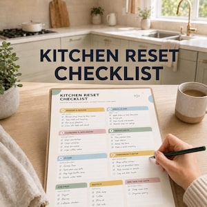 May include: A printed kitchen reset checklist on a clipboard with a hand holding a black pen. The checklist features six numbered sections including remove and return, dishes and sink, counters and appliances, fridge check, floor, and tomorrow's setup.