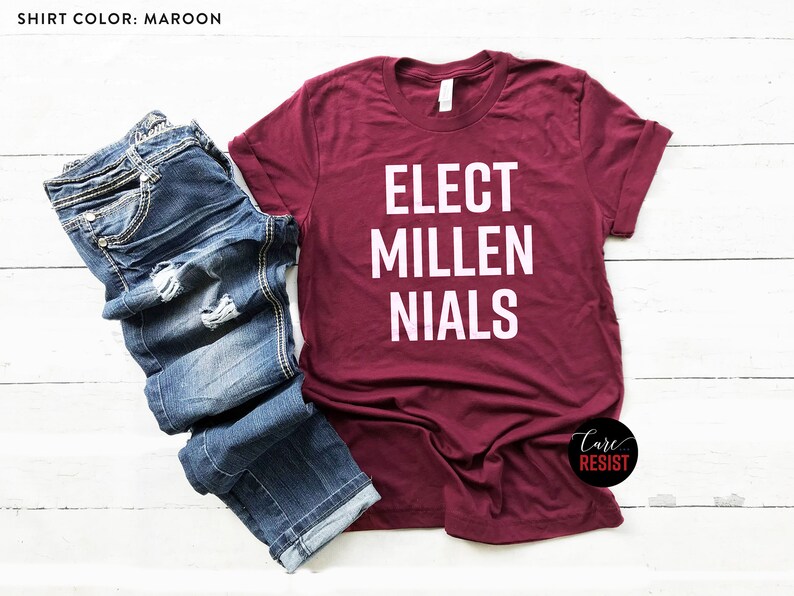 May include: A maroon t-shirt with white text that reads "Elect Millenials".