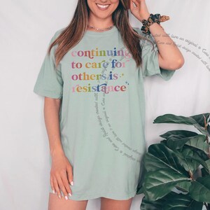 Kind kindness inclusion DEI diversity peace love equity liberal progressive t shirt t-shirt tshirt tee top apparel merch democrat hope solidarity activist activism protest equal rights diverse unity indivisible united stand divided we fall political compassion women LGBTQ trans transgender human being privilege rbg ruth Bader Ginsburg caring about other people mlk Martin luther king jr inspiration inspirational motivational motivate unity unite anti maga trump we rise by lifting others stand