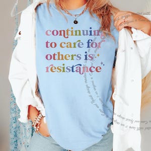 Kind kindness inclusion DEI diversity peace love equity liberal progressive t shirt t-shirt tshirt tee top apparel merch democrat hope solidarity activist activism protest equal rights diverse unity indivisible united stand divided we fall political compassion women LGBTQ trans transgender human being privilege rbg ruth Bader Ginsburg caring about other people mlk Martin luther king jr inspiration inspirational motivational motivate unity unite anti maga trump we rise by lifting others stand