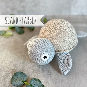 Lovingly crocheted musical turtle for little boys; in modern Scandinavian colors blue, natural, white; machine washable; approx. 21x10x18 cm