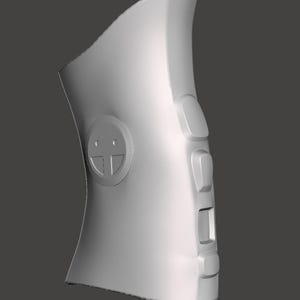May include: A light gray, curved electronic device featuring a circular emblem with a smiley face design on the side. The device includes four rectangular buttons arranged vertically along the right edge, with a smooth, matte-textured surface.