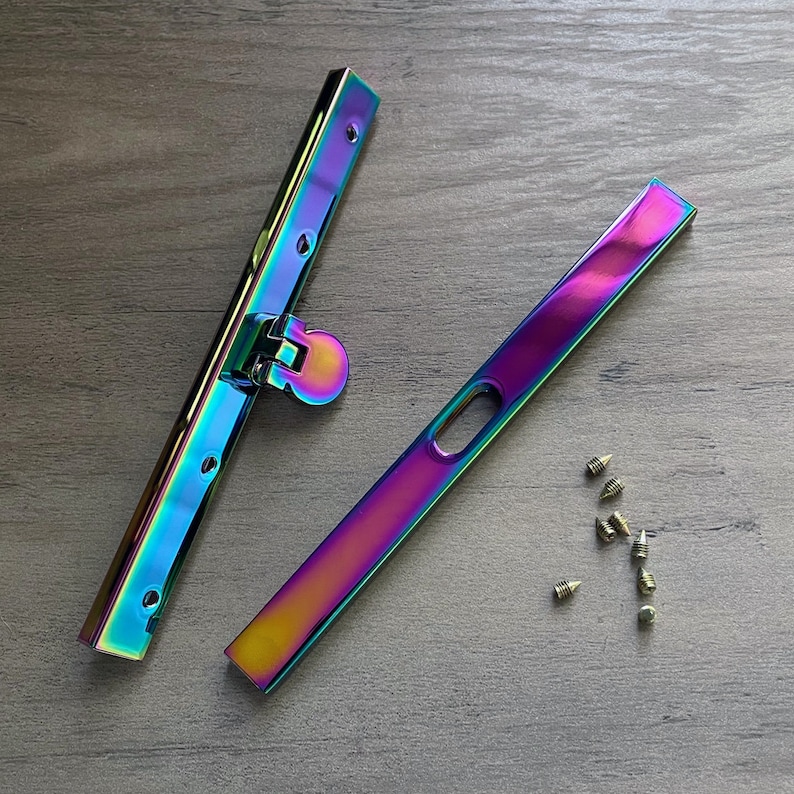 May include: Two iridescent metal purse frame clasps with a small metal hinge and a set of small gold screws.
