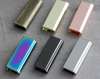 May include: Six metal slider buckles in different colors: antique brass, gold, rose gold, iridescent, black, and silver.