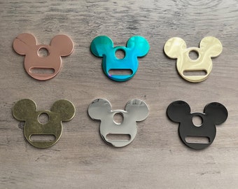 May include: Six metal Mickey Mouse-shaped charms in different colors: rose gold, teal, gold, silver, black, and antique brass.