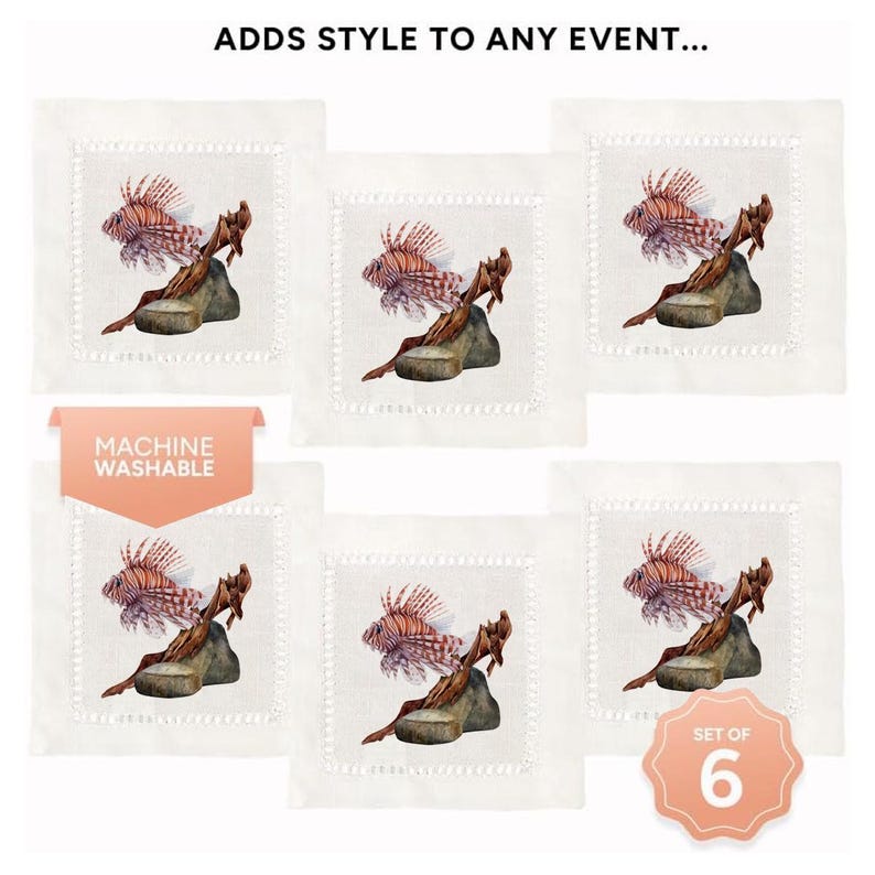 May include: Set of six white linen cocktail napkins with a red and orange lionfish design. The napkins feature a machine washable label. "Set of 6" is printed on the bottom right corner of the image.