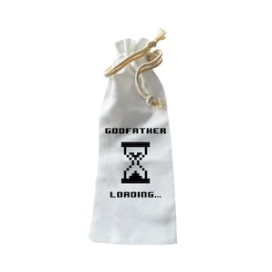 May include: White fabric wine bottle bag with a drawstring closure. The bag features the text "GODFATHER" above a pixelated hourglass graphic, with "LOADING..." below. The drawstring is made of a natural-coloured rope.