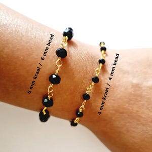 May include: Two black beaded bracelets with gold-colored wire. One bracelet has 6 mm beads, and the other has 4 mm beads. The text on the image reads "6 mm bead" and "4 mm bead".