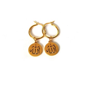 May include: Gold hoop earrings with a dangling charm featuring the Arabic word "Allah" in a cut-out design.