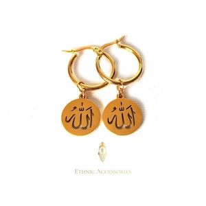 May include: Gold hoop earrings with a round pendant featuring the Arabic word "Allah" in a cut-out design.