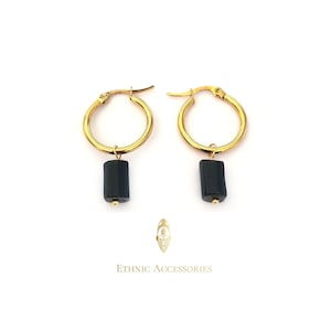 May include: Gold hoop earrings with black rectangular pendant charms.  The earrings are simple and elegant.