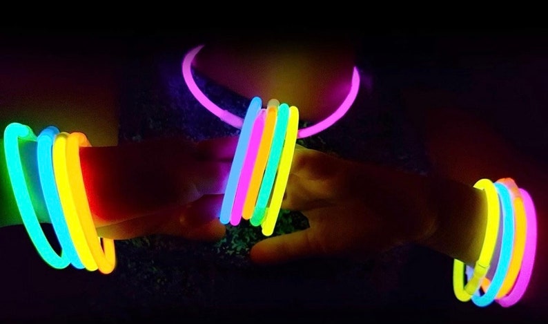 May include: A set of glow sticks in various colours, including pink, yellow, blue, and green. The glow sticks are arranged in a circle around a person's wrist and neck.