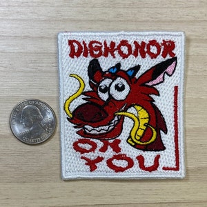 May include: White embroidered patch with a red cartoon dragon with yellow horns and a white background. The text "DISHONOR ON YOU" is embroidered in red.