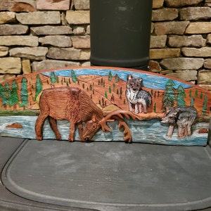 Carving of Elk Hunted by Wolves