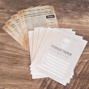 May include: A stack of cream-colored invitations with a skull graphic and the text "You are formally invited to MIDNIGHT MANOR for a party to die for."  The invitations have a decorative border and are printed on a textured paper.