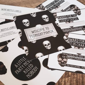 May include: A set of black and white printable party decorations with a skull motif. The decorations include wine bottle labels, award cards, and a welcome sign that says "Welcome to Midnight Manor".
