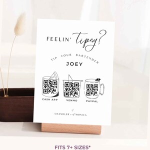 May include: White sign with black text that reads "FEELIN' Tipsy? TIP YOUR BARTENDER JOEY".  Three black and white QR codes are displayed below the text with the labels "CASH APP", "VENMO", and "PAYPAL".  The text "CHANDLER & MONICA" is below the QR codes.  The sign is on a wooden stand.  The text "FITS 7+ SIZES* 11x14" 8.5x11" 8x10" 5x7" 4X6" A4 A6 *can be DIY custom resized" is below the sign.