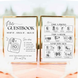 May include: A printable wedding guestbook sign with a black and white illustration of an instant camera. The sign says "Photo Guestbook" and "Snap it. Stick it. Sign it."  It also includes instructions on how to take a photo and load new film. The sign is available in three sizes: 5x7, 8x10, and A4.