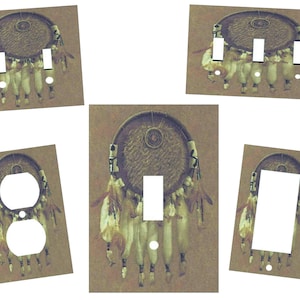 May include: Set of five light switch and outlet covers featuring a brown and white dreamcatcher design with feathers. The dreamcatcher is on a brown background.