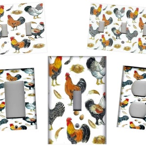 May include: A set of five light switch and outlet covers featuring a white background with a repeating pattern of roosters, hens, eggs, and feathers. The roosters are red, orange, and yellow with black and white markings. The hens are gray and white with black markings. The eggs are white and yellow. The feathers are white and brown.