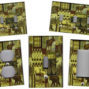 May include: Set of six light switch and outlet covers featuring a woodland scene with a moose, deer, bear, pine cones, and a patchwork design in shades of green, brown, and beige.