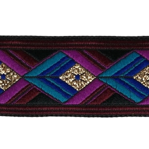 May include: Purple, teal, and gold geometric patterned trim with a black background.