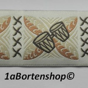 May include: White fabric trim with a brown and beige pattern. The pattern includes palm trees, drums, and floral designs.