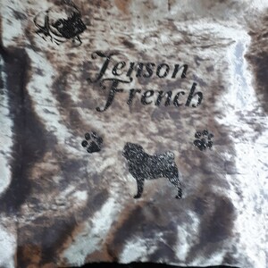 May include: A gray and white patterned dog bed with black paw prints and the text "Jenson French" in black cursive lettering. A black silhouette of a French Bulldog is also visible on the bed.
