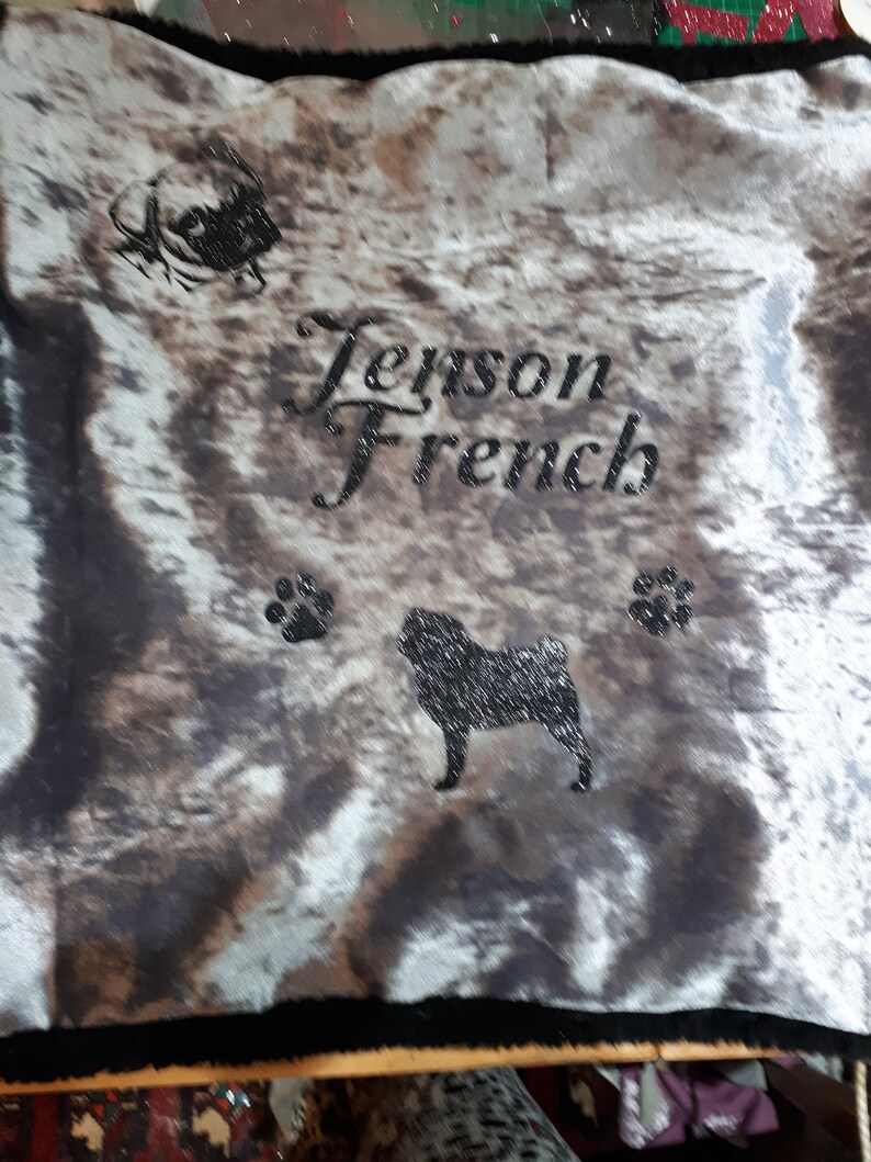 May include: A gray and white patterned dog bed with black paw prints and the text "Jenson French" in black cursive lettering. A black silhouette of a French Bulldog is also visible on the bed.