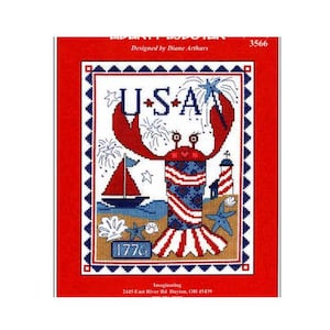 May include: A cross-stitch pattern featuring a patriotic design with a red lobster holding the letters "USA". The image includes a sailboat, lighthouse, and the number "1776". The design is set against a red background.