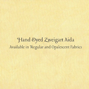 Puede incluir: Primer plano de una tela texturizada de color amarillo claro. El texto "Hand Dyed Zweigart Aida" se muestra en una escritura elegante, con la línea "Available in Regular and Opalescent Fabrics" debajo.