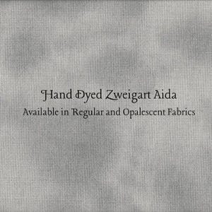Puede incluir: Primer plano de una tela gris con el texto "Hand Dyed Zweigart Aida" y "Available in Regular and Opalecent Fabrics". La tela tiene un aspecto texturizado.