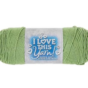 May include: A skein of light green yarn with a label that reads "I Love This Yarn!" in blue and white. The yarn is tightly wound and appears soft, suitable for various knitting and crochet projects.