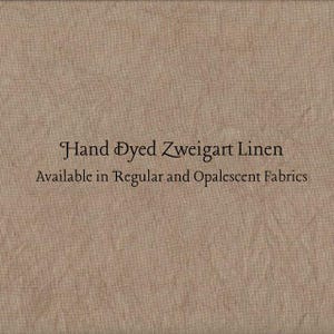 May include: Close-up of a tan-colored fabric with the text "Hand Dyed Zweigart Linen" and "Available in Regular and Opalescent Fabrics". The fabric has a textured appearance.