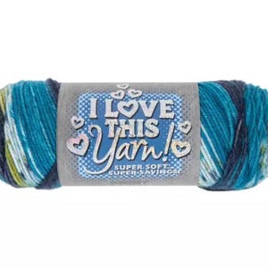 May include: A skein of variegated yarn in shades of teal, navy blue, and white. The center label features the text I LOVE THIS YARN! SUPER SOFT SUPER SAVINGS with a blue background, white polka dots, and several white heart-shaped outlines.