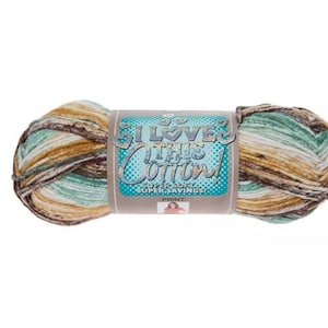 May include: A skein of multi-colored yarn with shades of brown, teal, and tan. The label reads "I Love This Cotton!" in a teal and white design. The yarn is a print variety, perfect for knitting and crochet projects.