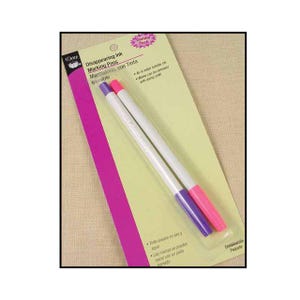 May include: A package of two white disappearing ink marking pens. One pen has a pink tip, and the other has a purple tip. The package has text that says "Disappearing Ink Marking Pens" and "Combo Pack".