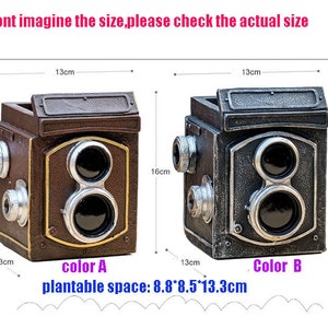 May include: Two vintage camera-shaped planters, one brown and one silver, with a plantable space of 8.8 x 8.5 x 13.3 cm. The planters are 13 cm wide and 16 cm tall.