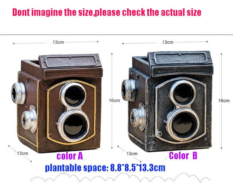 May include: Two vintage camera-shaped planters, one brown and one silver, with a plantable space of 8.8 x 8.5 x 13.3 cm. The planters are 13 cm wide and 16 cm tall.