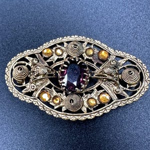 Art Deco brooch wonderful 1930s - 1940s C clasp brooch decorated with a purple crystal stone, light brown rhinestones, filigree