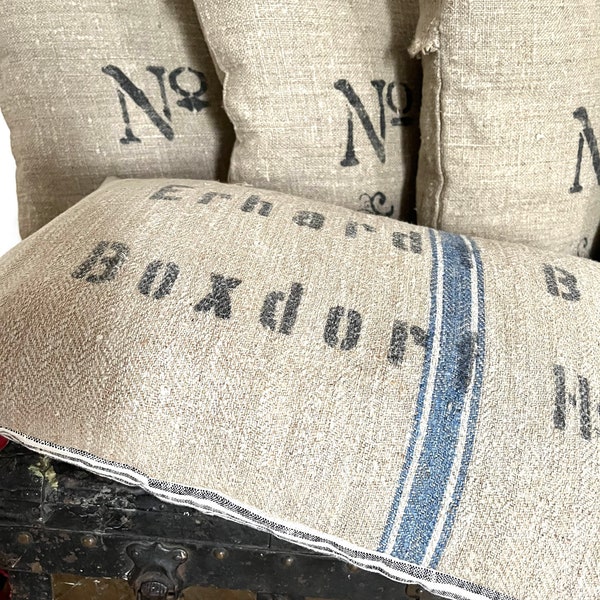 Vintage pillow made from old linen sack with inscription and filling