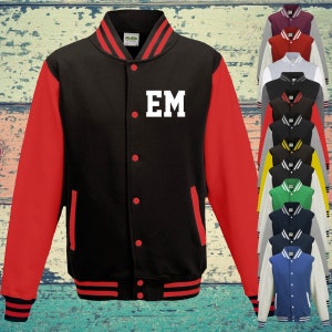 May include: A black varsity jacket with red sleeves, a striped collar, cuffs, and hem. The front features red snap buttons and the white letters EM on the left chest. A vertical column of various coloured varsity jackets is displayed on the right side.