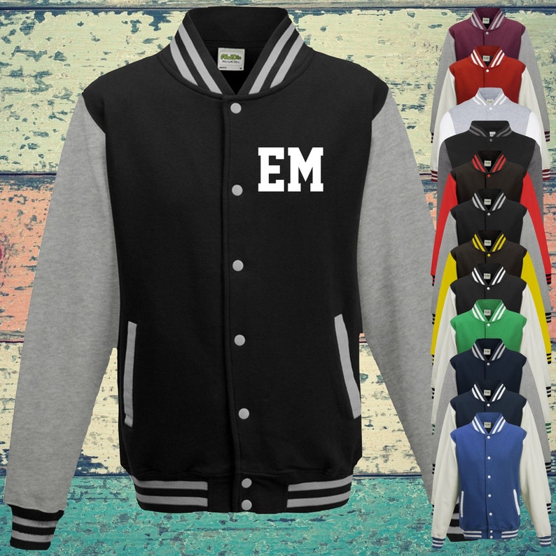 May include: A black varsity jacket with grey sleeves, a striped collar, cuffs, and hem. The jacket features a front button closure, two side pockets, and the white letters EM printed on the chest. A vertical column of similar jackets in various colours.