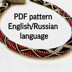 May include: A beaded necklace with a geometric pattern in red, black, and gold. The text "PDF pattern English/Russian language" is displayed on the image. The necklace is likely handmade and suitable for jewelry making.