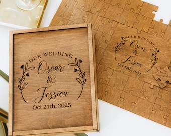 May include: A wooden box with a personalized inscription for a wedding. The inscription reads "OUR WEDDING Oscar & Jessica Oct 21th, 2025". The box is open and a wooden jigsaw puzzle is visible inside. The puzzle is also personalized with the couple's names and wedding date.
