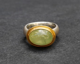 handmade , massive silver ring with 22 kt yellow gold bezel and light green cabochon (prenite)