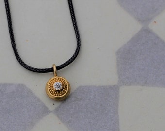little gold pendant with diamond and silver chain