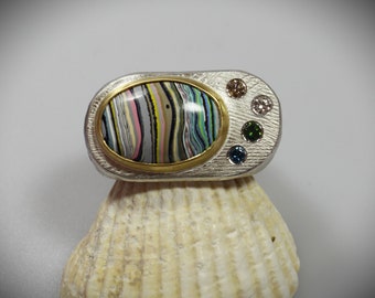 extravagant silverring with fordite and colored diamonds